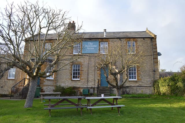 The pub seen from the orchard side by day
