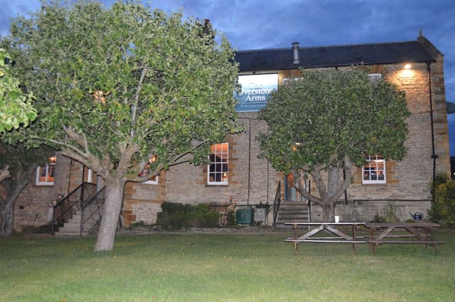 The pub seen from the orchard side at dusk