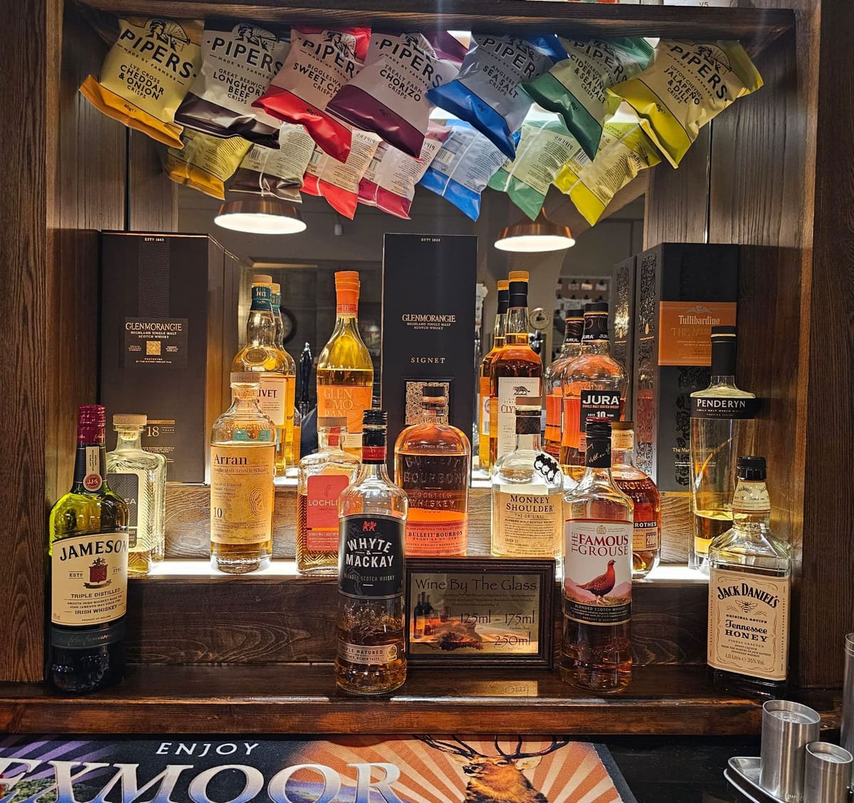 Behind the bar at The Overstone Arms, well-stocked spirit shelves