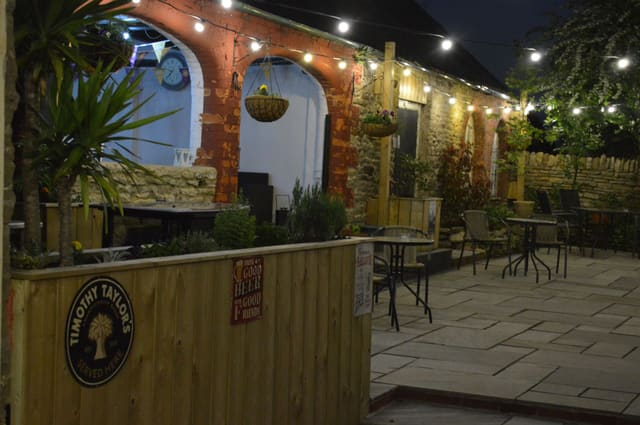 The Secret Garden courtyard at night, with string lights
